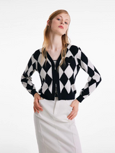 a lady wearing a black and white tencel woolen cardigan with an argyle print
